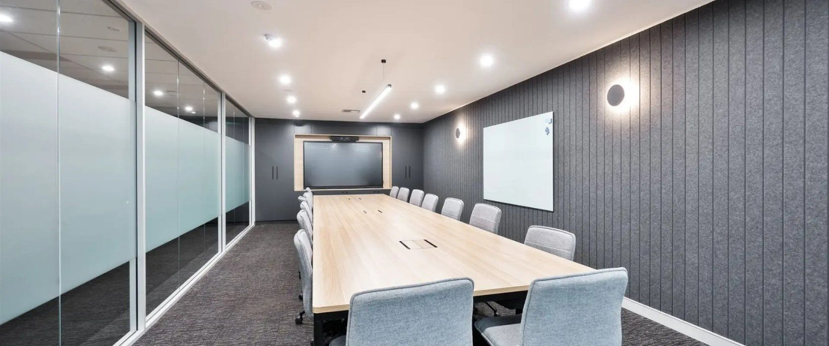 A Large Conference Room With a Long Table and Chairs — Moltus Construction in Braddon,  ACT