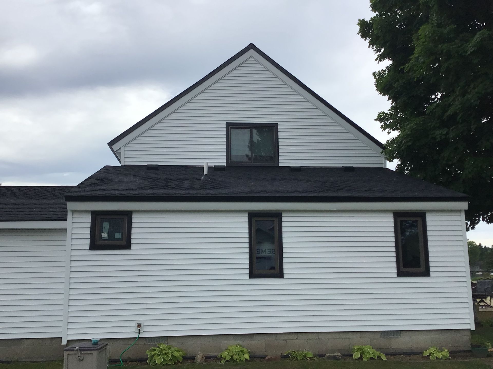 A white house with a black roof and black windows