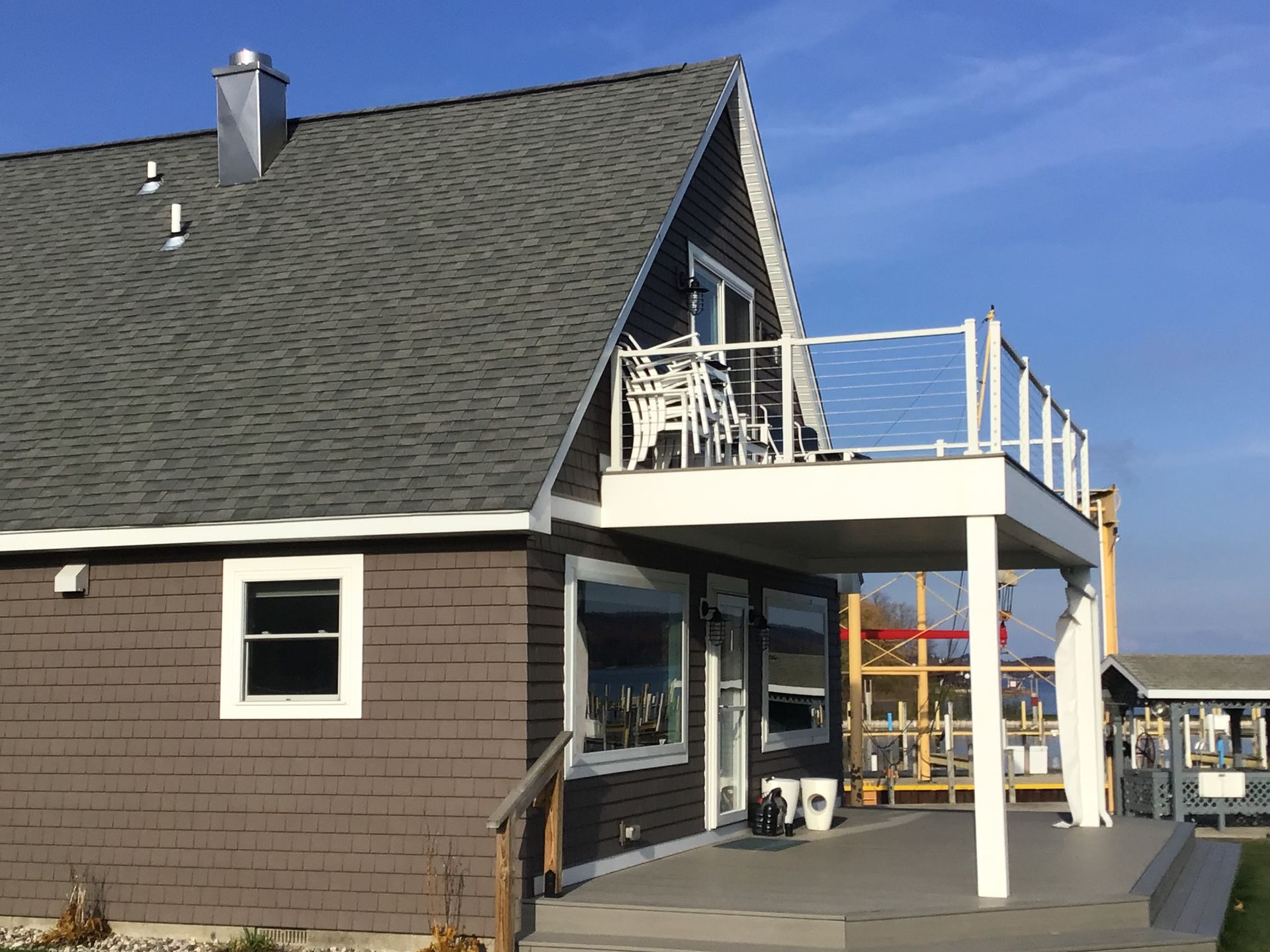 A house with a balcony and chairs on it