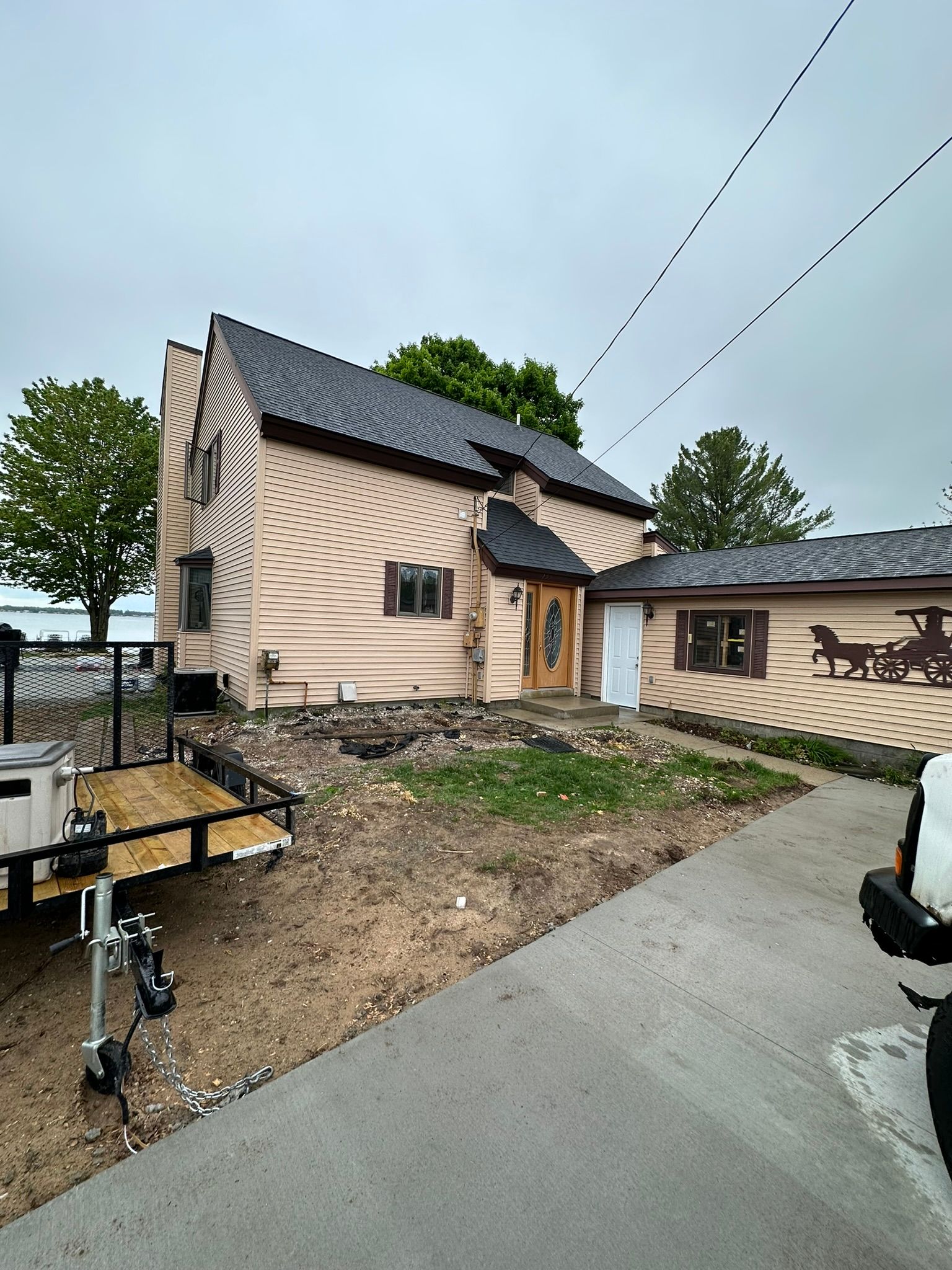 A large house with a trailer parked in front of it.