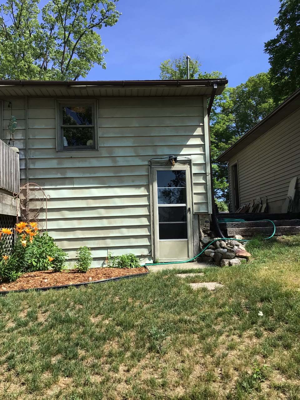 A small house with a screen door and a window