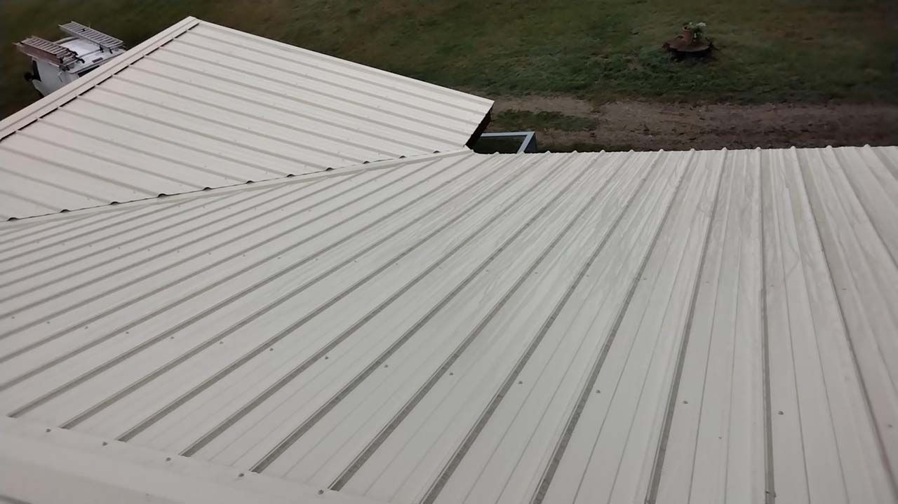 An aerial view of a white metal roof on a house.