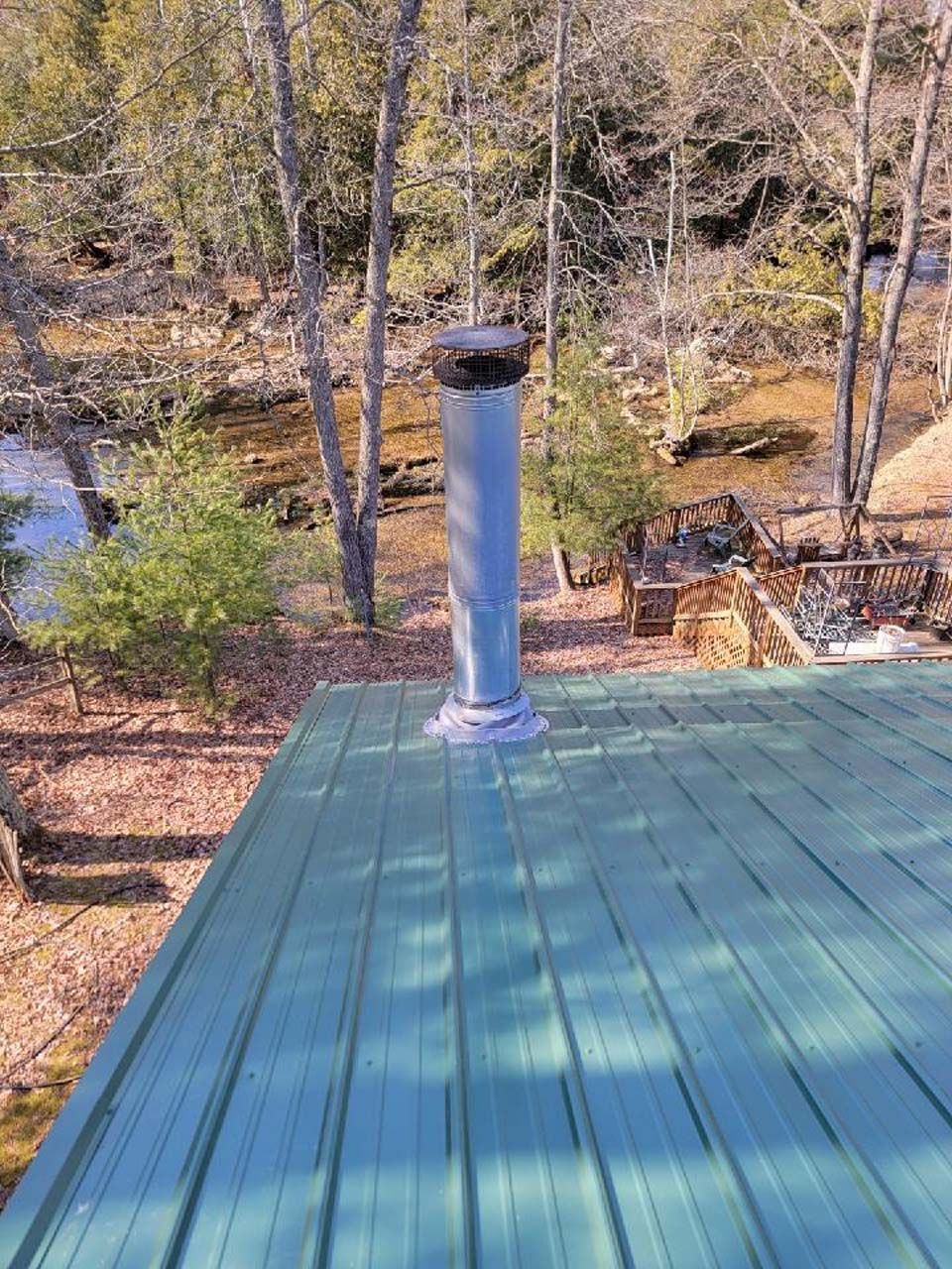 A green roof with a chimney on top of it