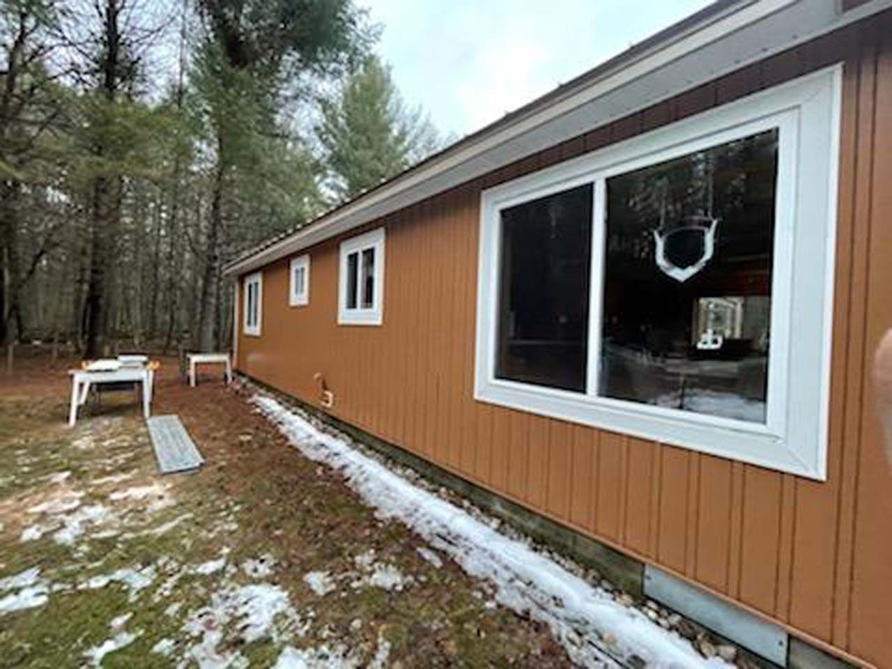 A mobile home with a lot of windows on the side of it.