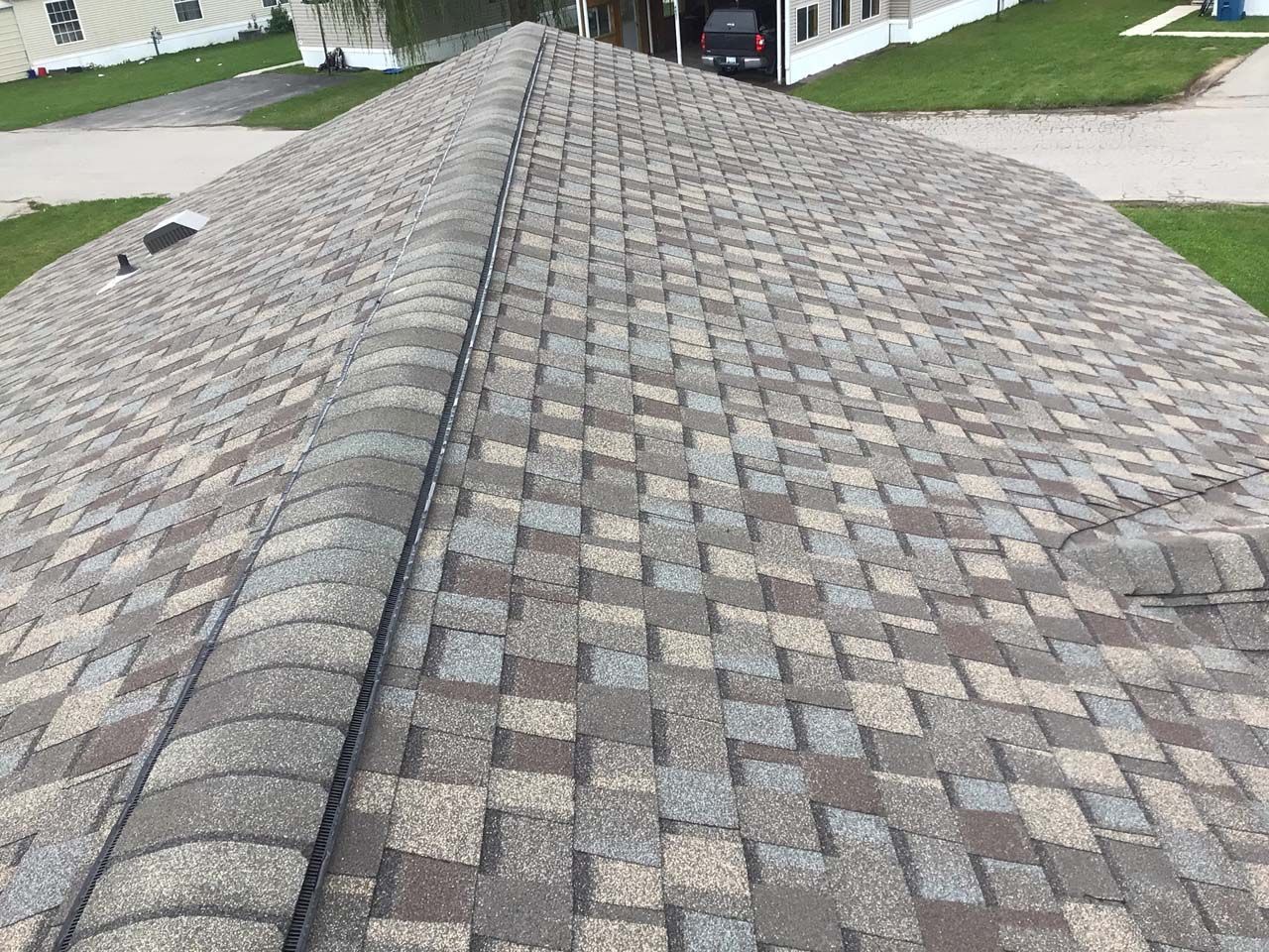 A close up of a roof with a lot of shingles on it.
