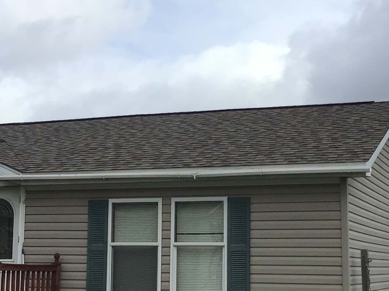 A small house with a roof and two windows.