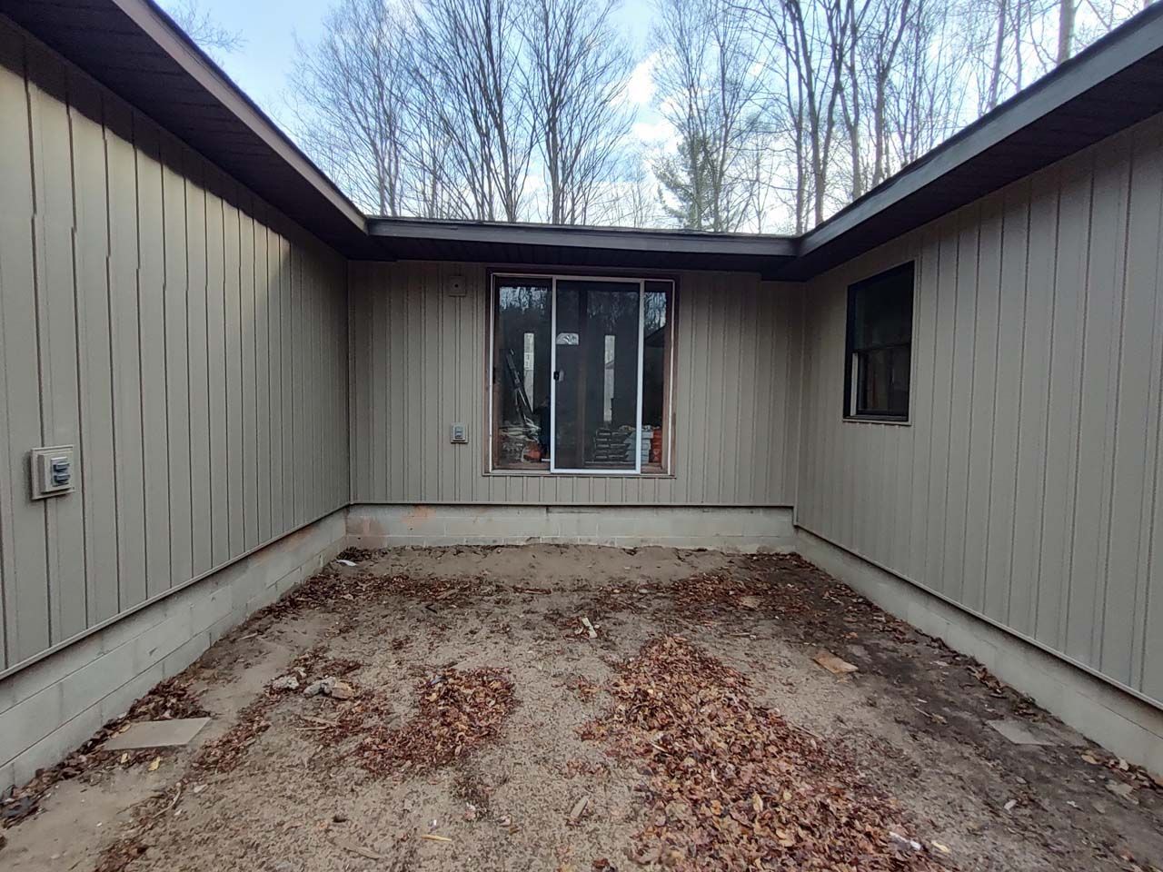 A house with a sliding glass door and a window