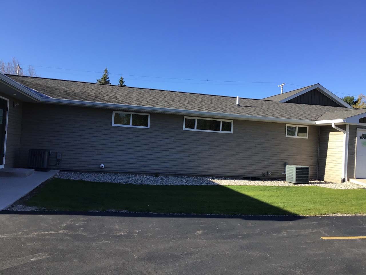 A house with a gray roof and a lot of windows