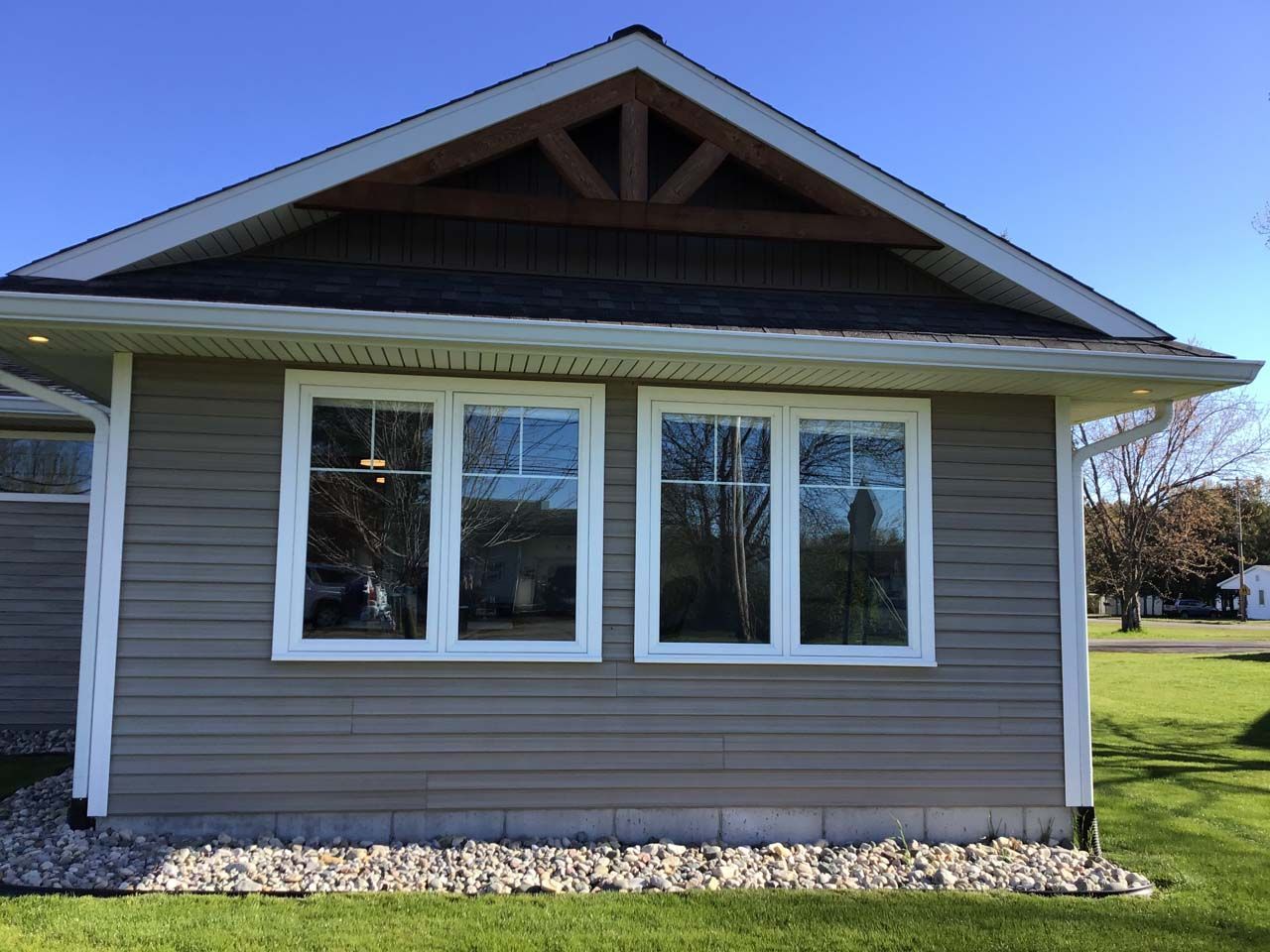 A small house with a lot of windows and a roof.