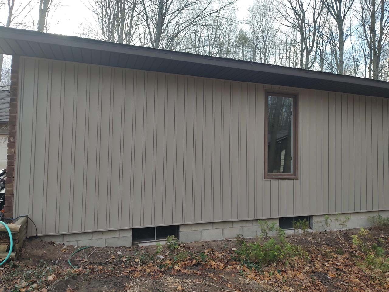 A small house with a window on the side of it.