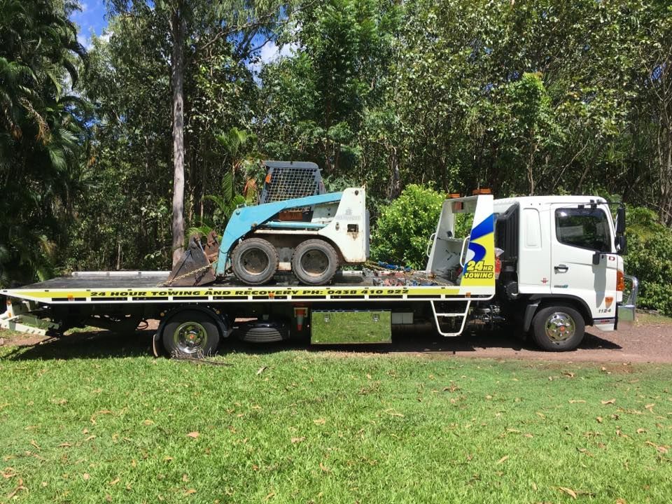 A White Flatbed Truck Parked On A Grassy Area — Auto Inspections & Road Services N.T. in Woolner, NT