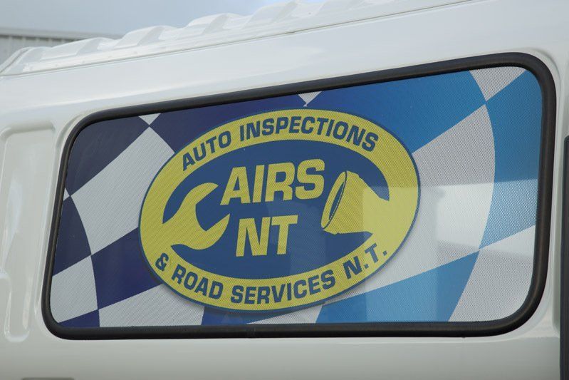 Blue and yellow AIRS NT auto inspections and road services logo on a vehicle window — Auto Inspections & Road Services N.T. in Woolner, NT