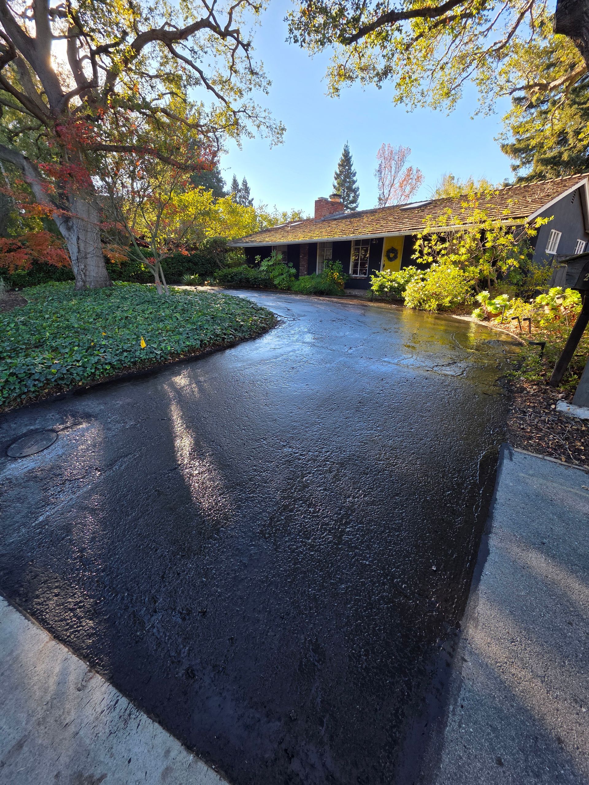 Family gathered at a dining table in a kitchen. They are eating and talking together.