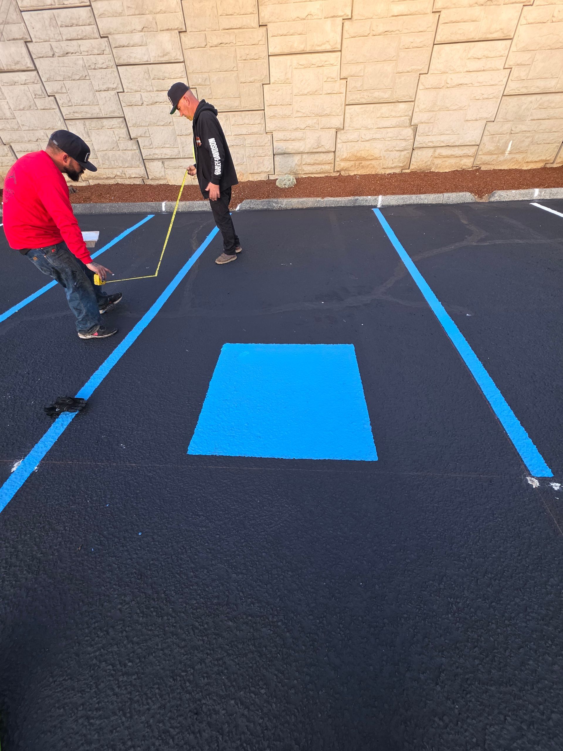 A person holding a baby up in the air indoors near a window, baby smiling.