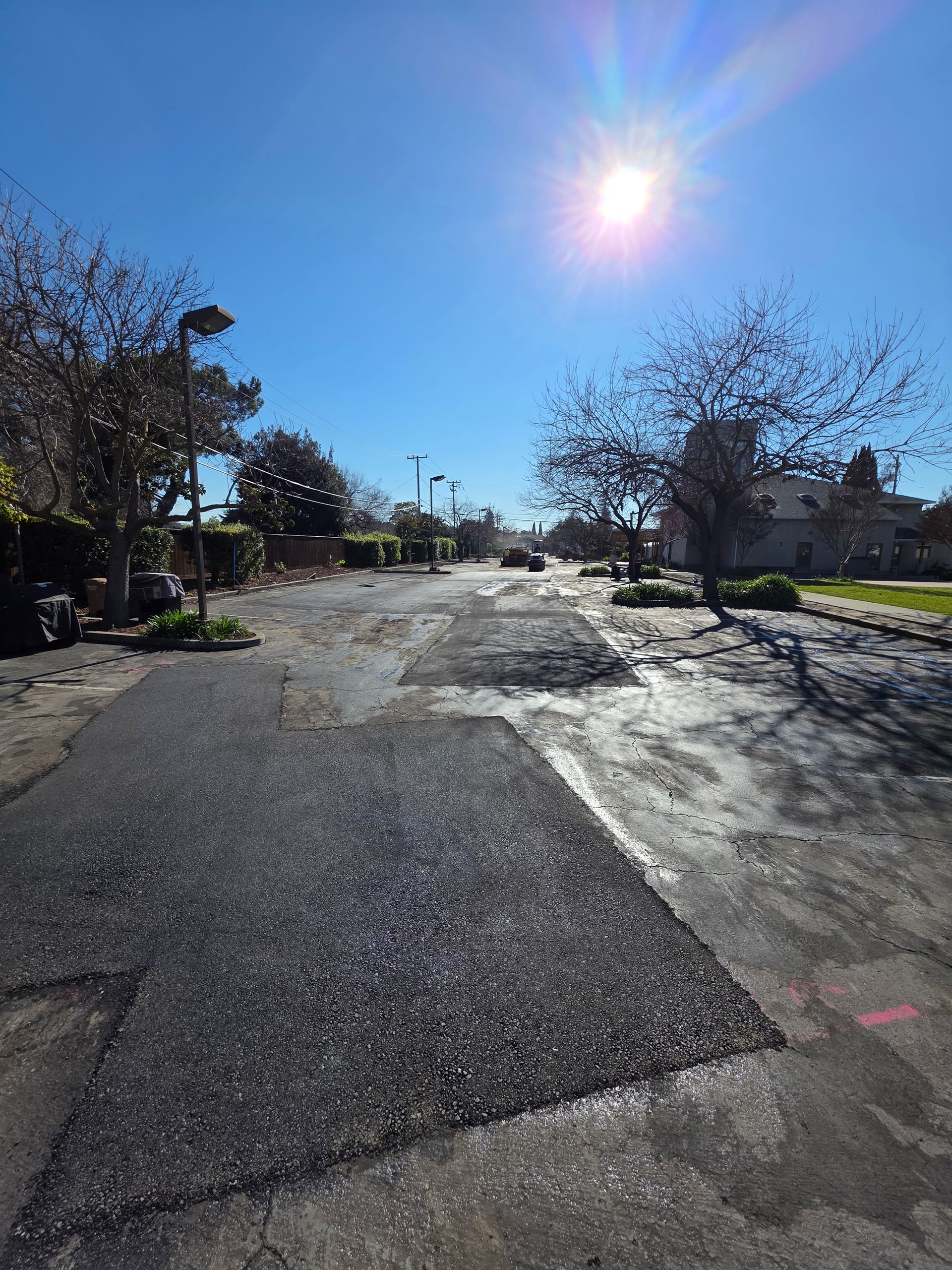 A person holding a baby up in the air indoors near a window, baby smiling.