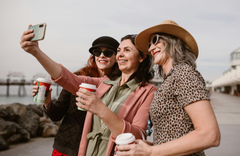 An older woman wearing a red hat and sunglasses