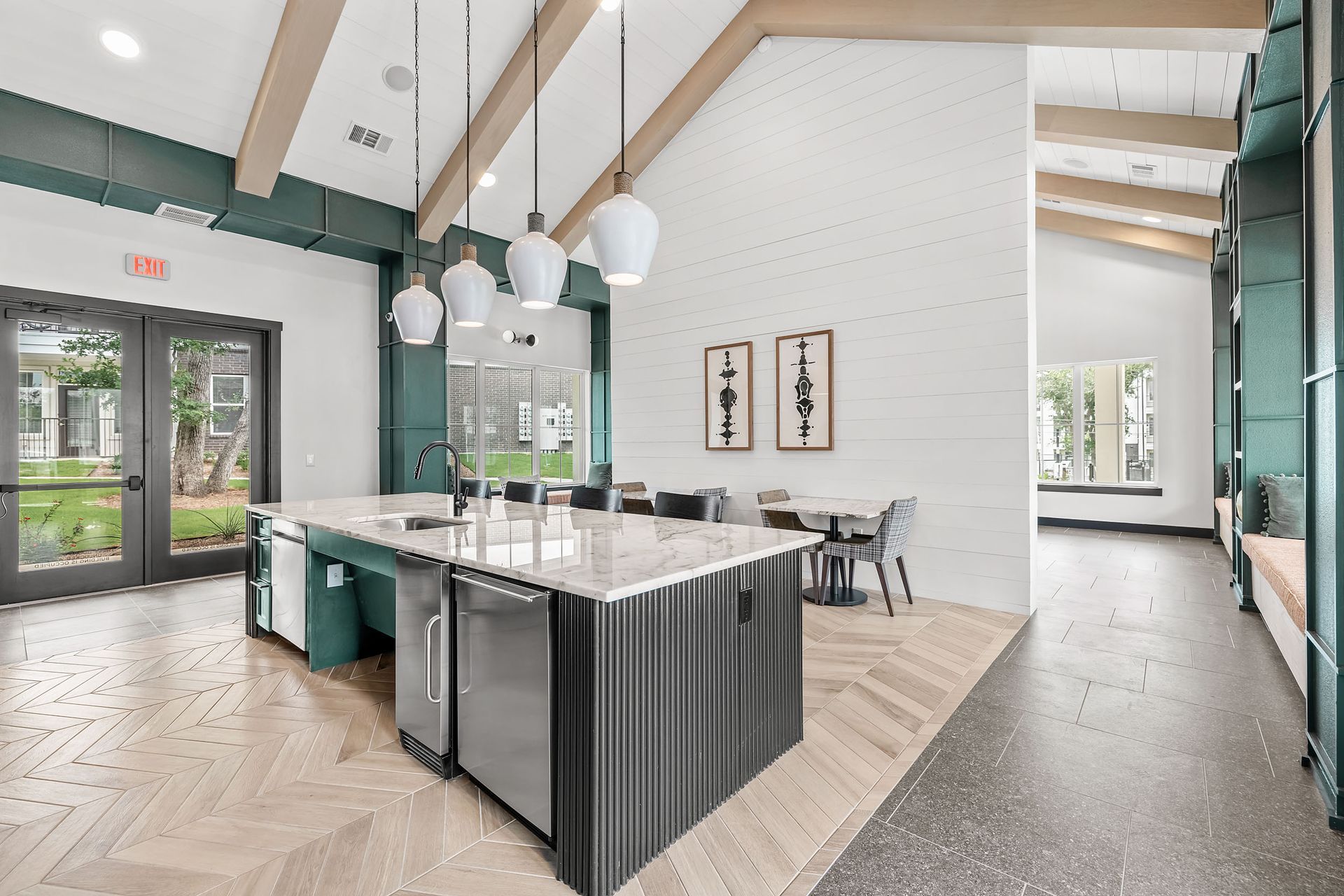 Clubhouse kitchen with a large island, stainless steel appliances, and seating areas at The Gabriel, which offers apartments near Georgetown.