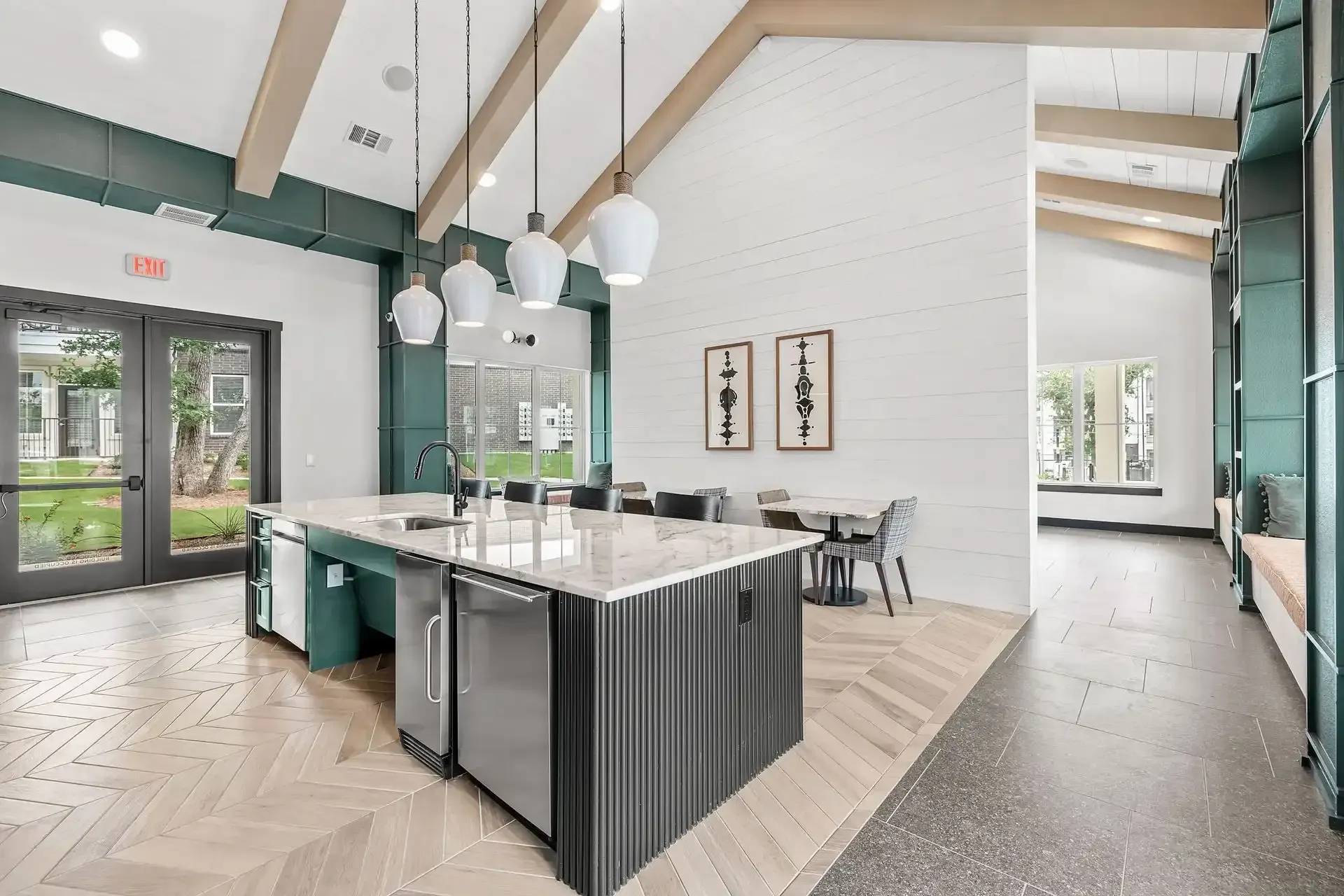 Clubhouse kitchen with a large island, stainless steel appliances, and seating areas at The Gabriel, which offers apartments near Georgetown.