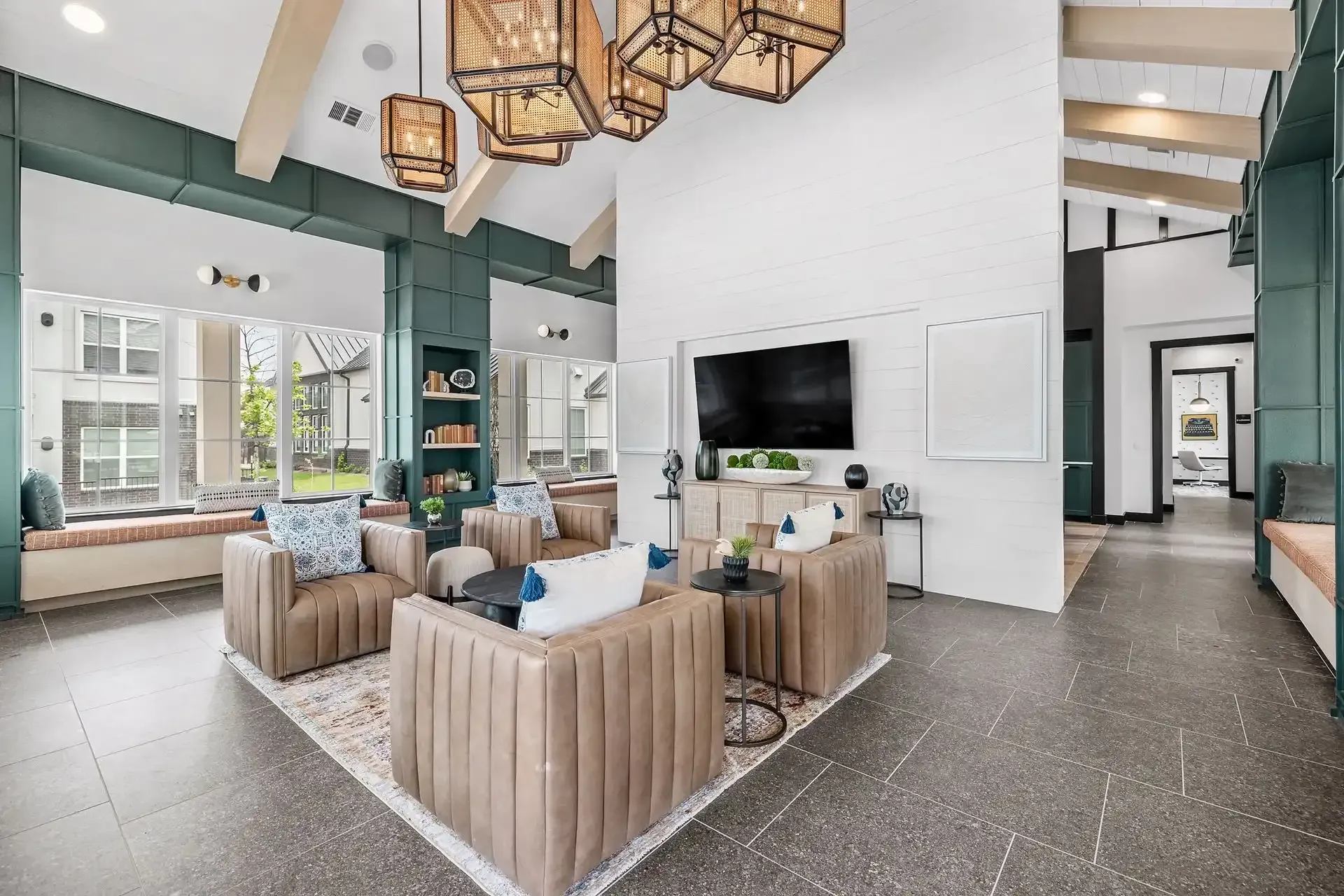 Spacious clubhouse filled with furniture and a flat-screen TV at The Gabriel, which offers apartments for rent with easy access to 183A Toll Rd.