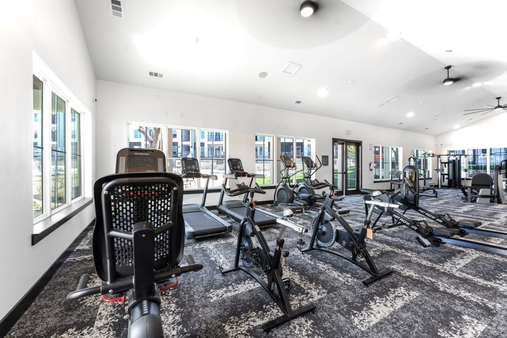 A large fitness center filled with exercise equipment at The Gabriel, which offers apartments for rent in Leander.