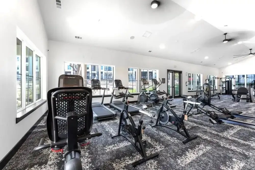 A large fitness center filled with exercise equipment at The Gabriel, which offers apartments for rent in Leander.