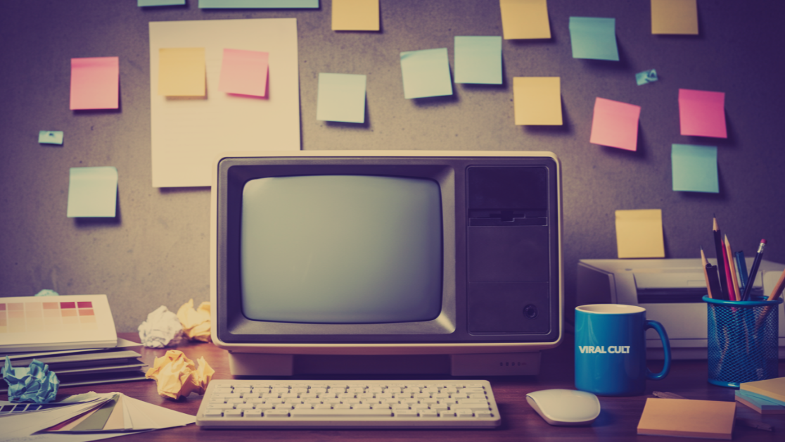 Boring set up of a computer and desk with blank colorful notes in the background.