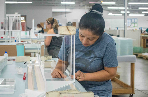 An Exactec employee assembling a display case