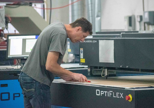 Exactec employee creating a plastic display