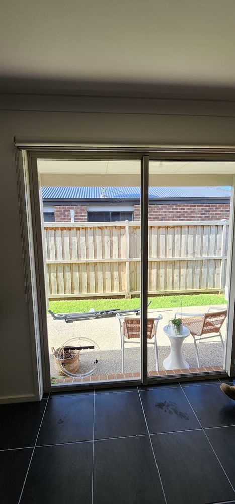 A living room with a sliding glass door leading to a patio.