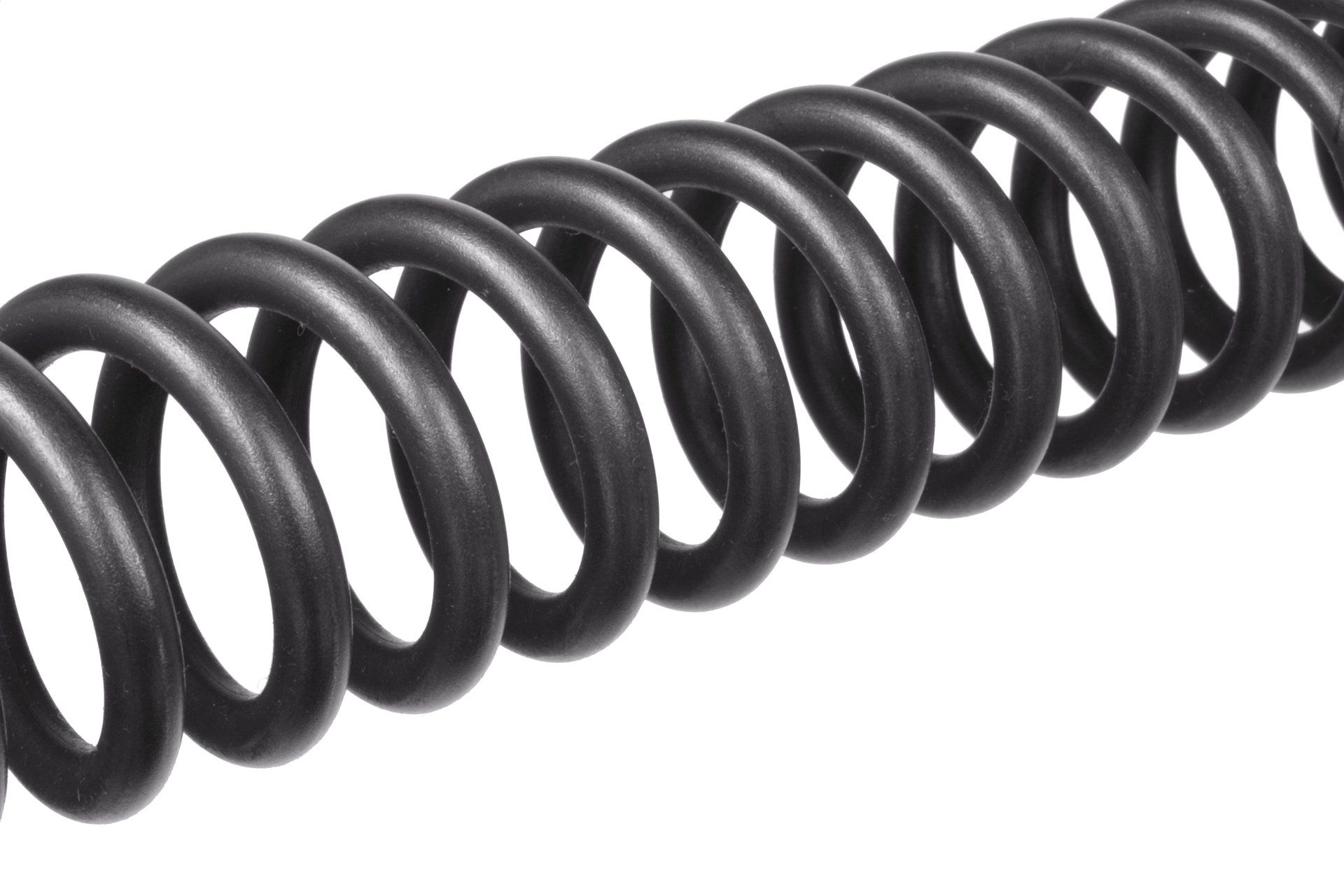A close up of a black spiral spring on a white background.