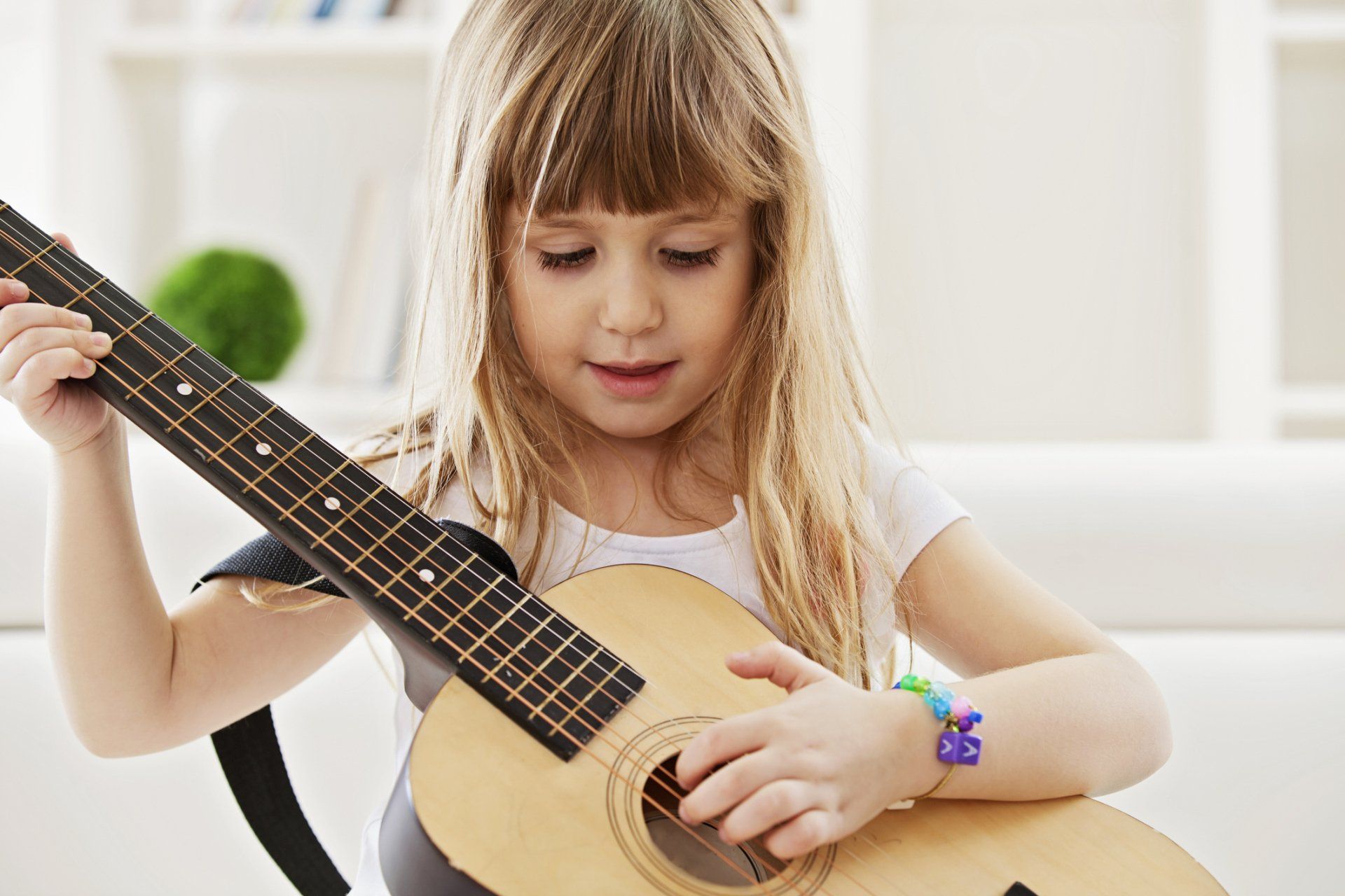 Child Playing a Guitar
