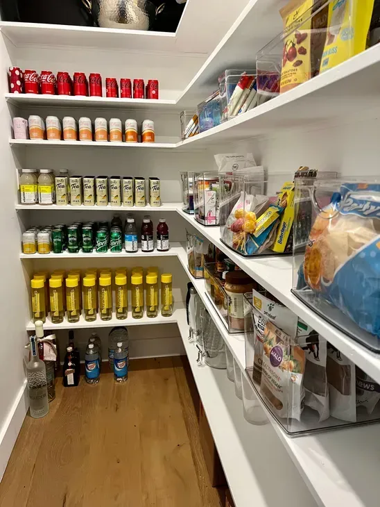 A pantry filled with lots of food and drinks.