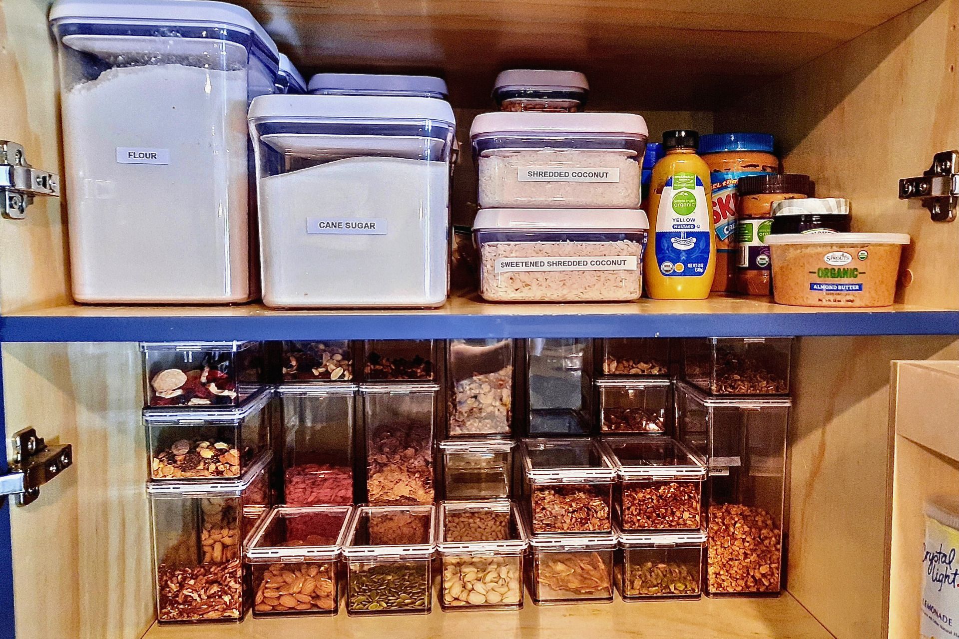 A pantry filled with lots of containers of food and condiments.
