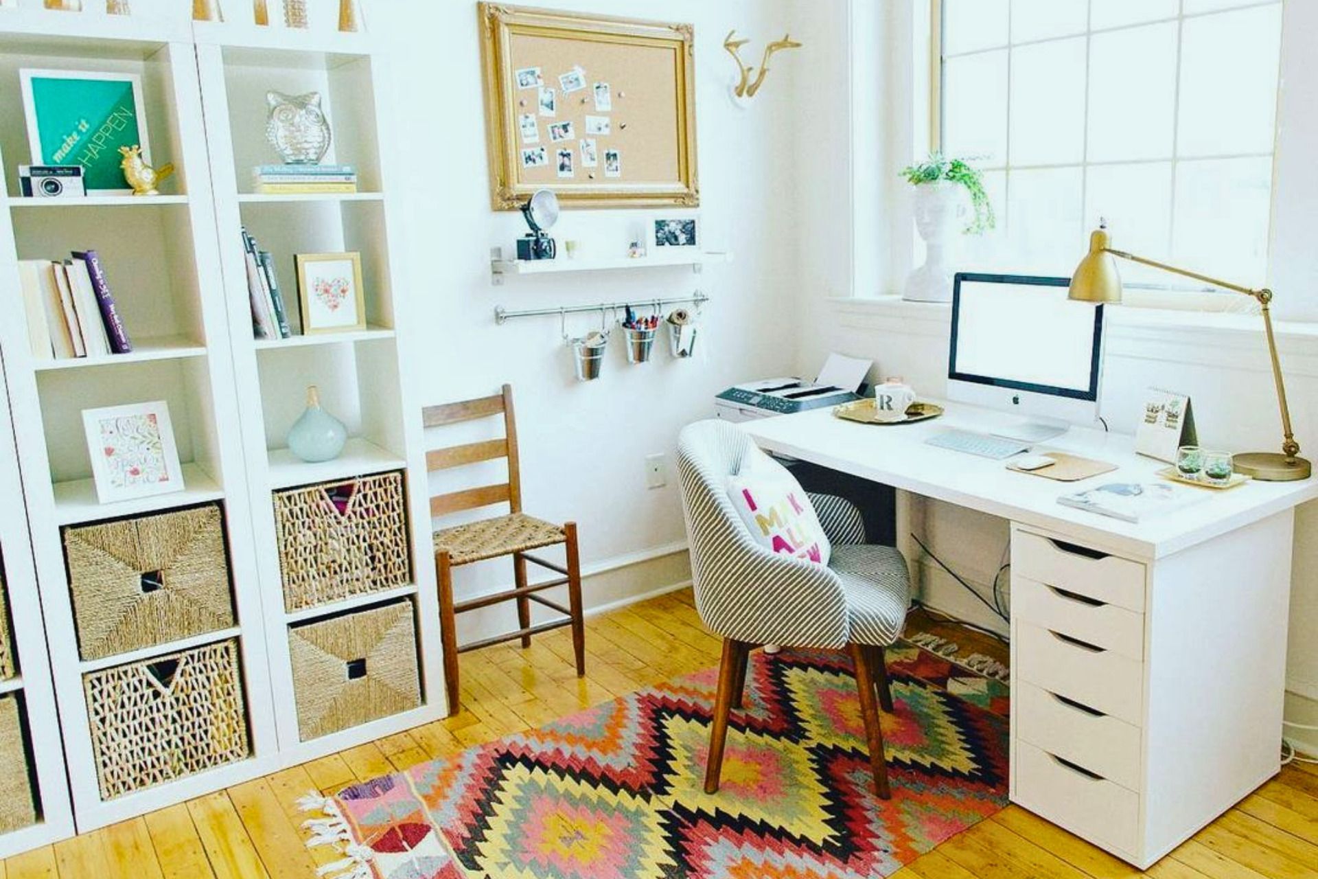A home office with a desk , chair , lamp and computer.