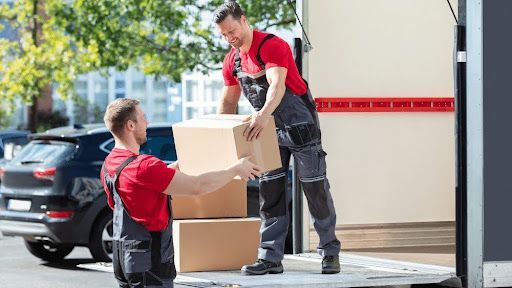 Professional movers loading boxes into trucks for a smooth move.