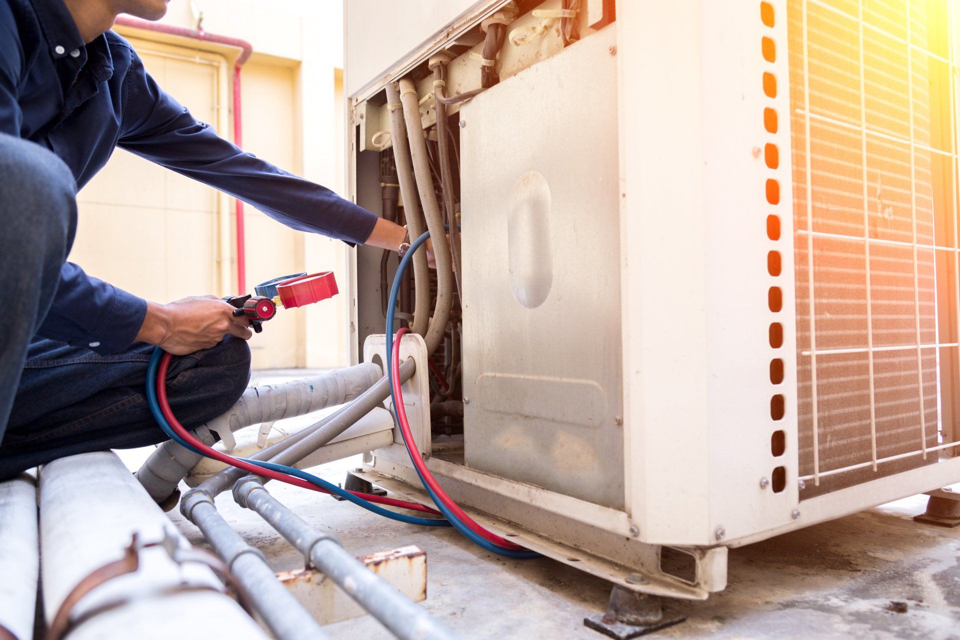 An HVAC technician installing a residential heating, ventilation, and air conditioning (HVAC) system.