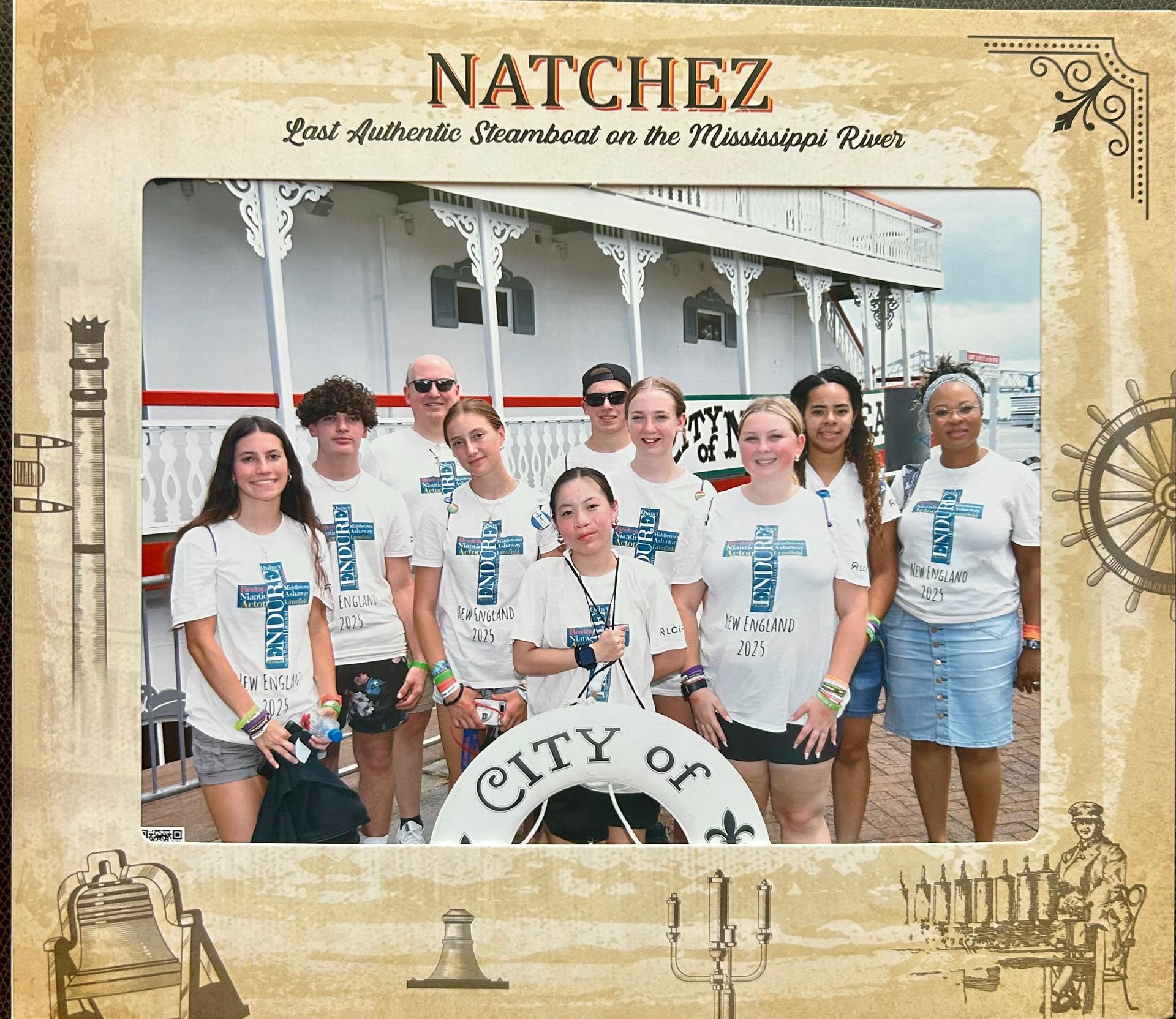 Group of people in white shirts with a sternwheeler,