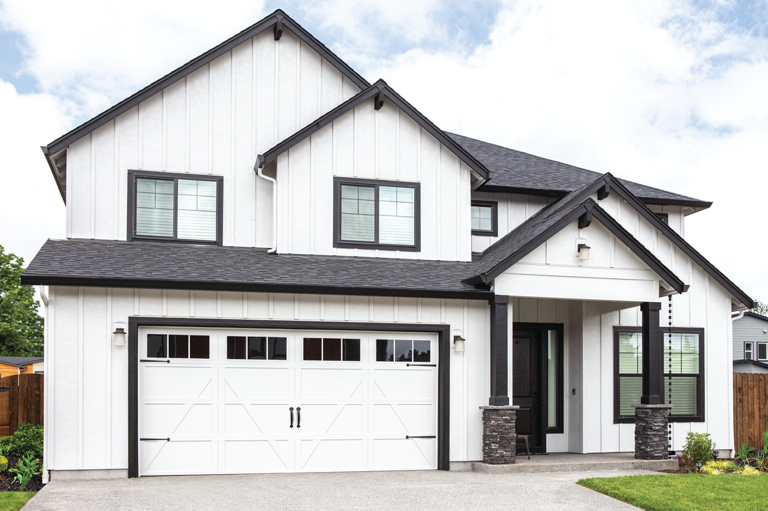 A large white house with black trim and a black roof.