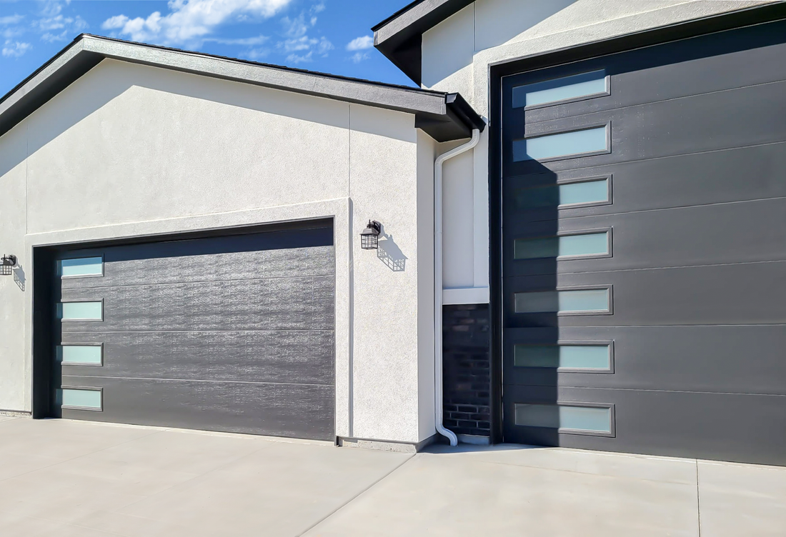 There are two garage doors on the side of a house.