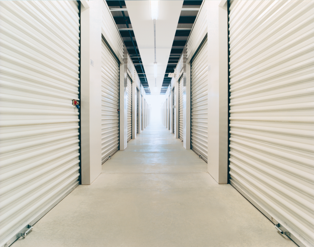 A long hallway with a lot of white doors