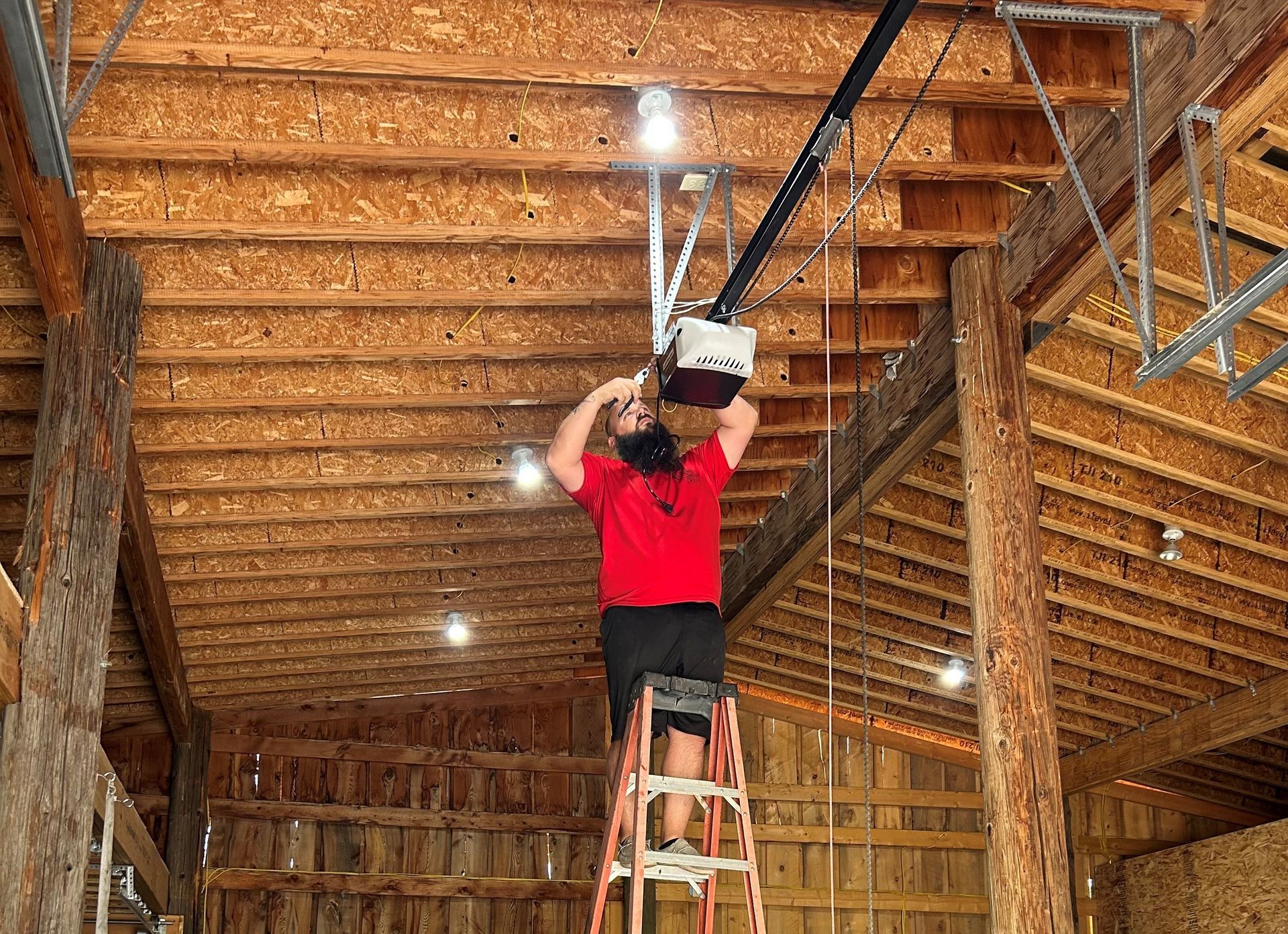 A large house with a tan garage door is sitting on top of a lush green lawn.