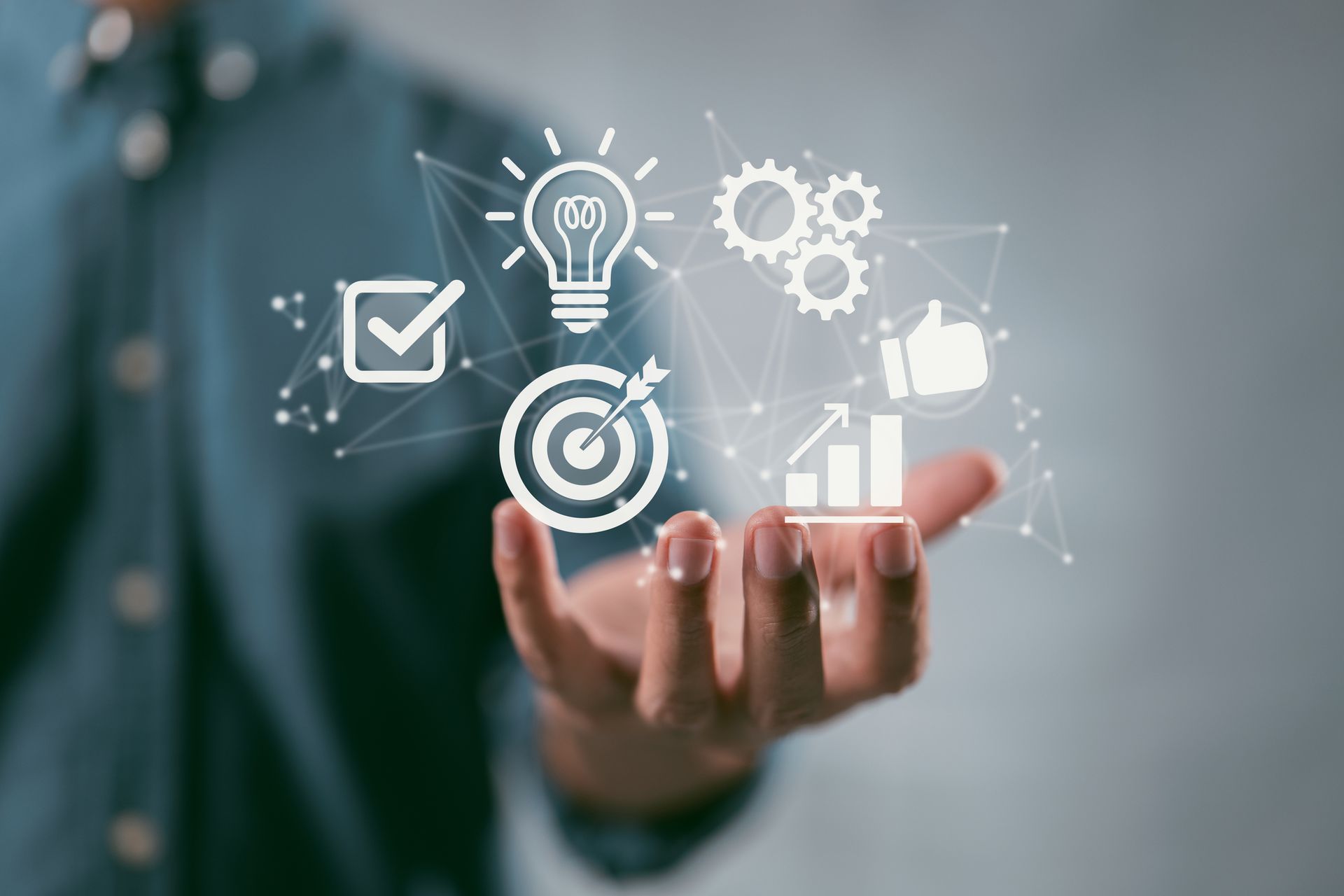 A person is holding a bunch of icons in their hands.