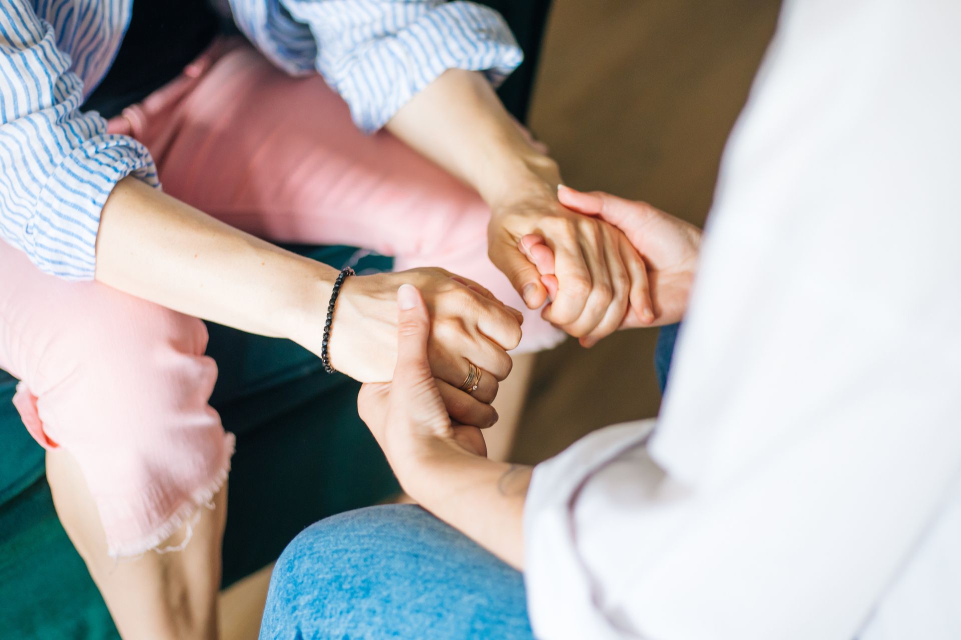 A group of women are sitting in a circle talking to each other.