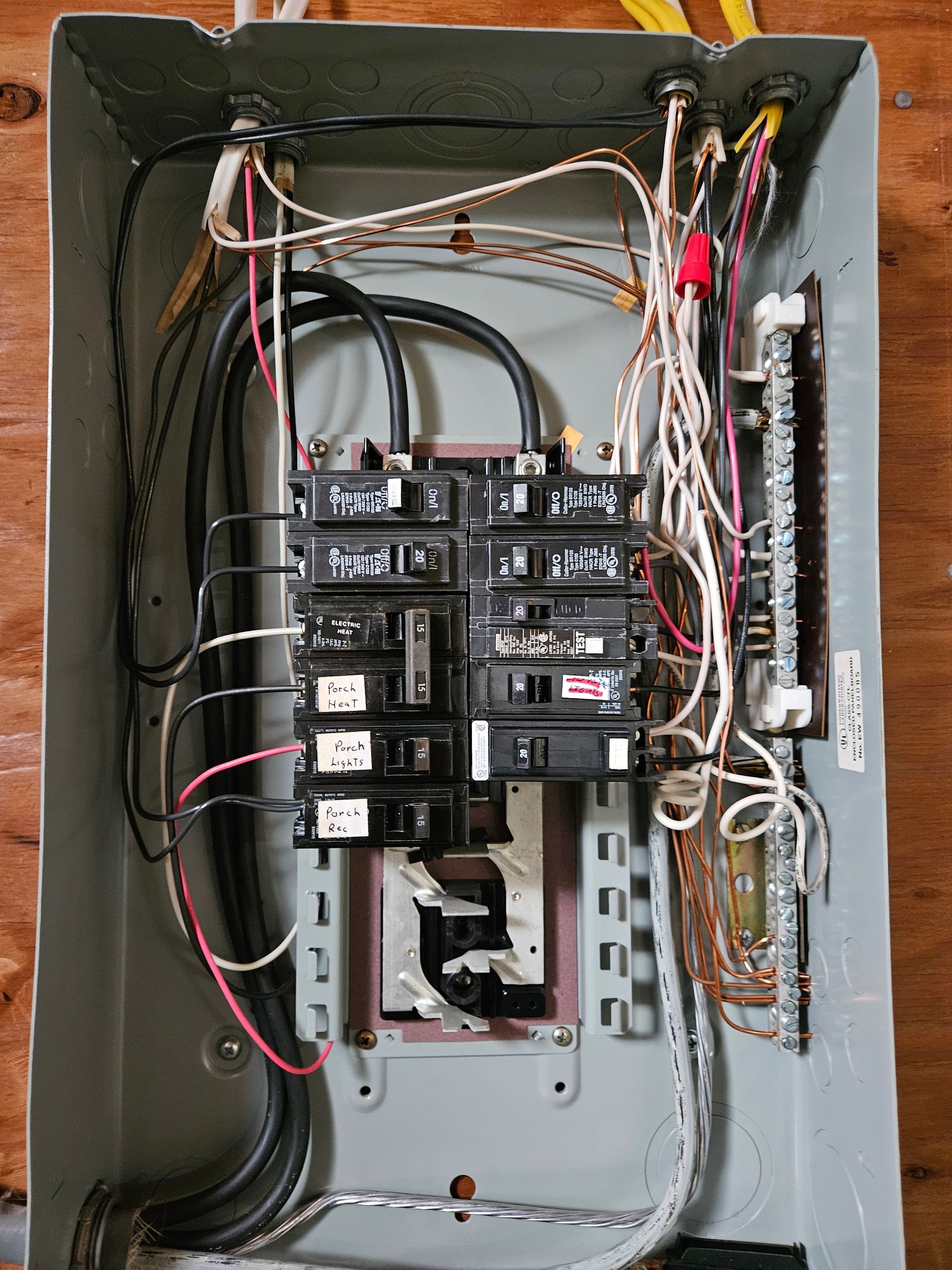 A very messy electrical box with a lot of wires coming out of it.