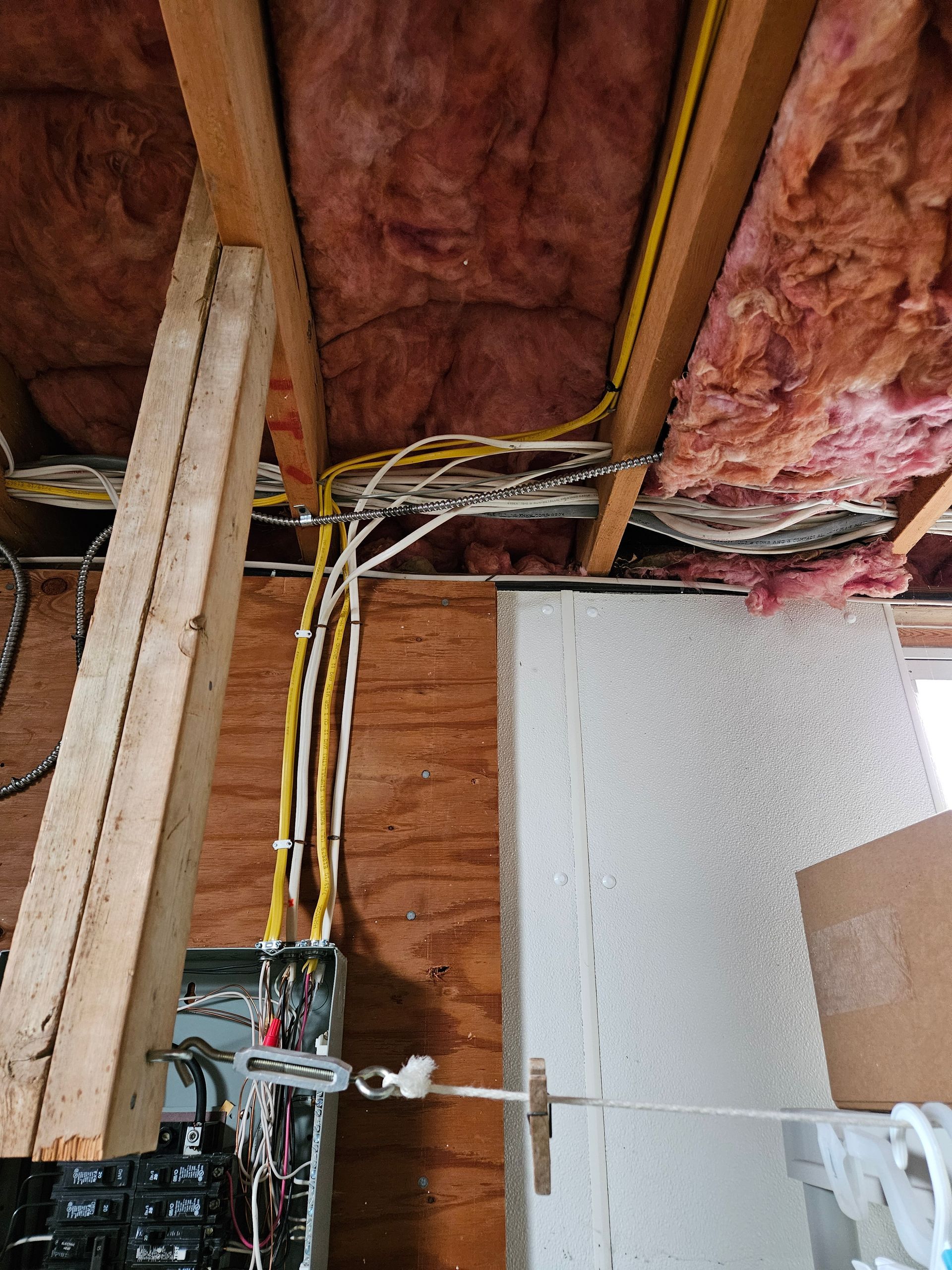 A bunch of wires are hanging from the ceiling of a building.