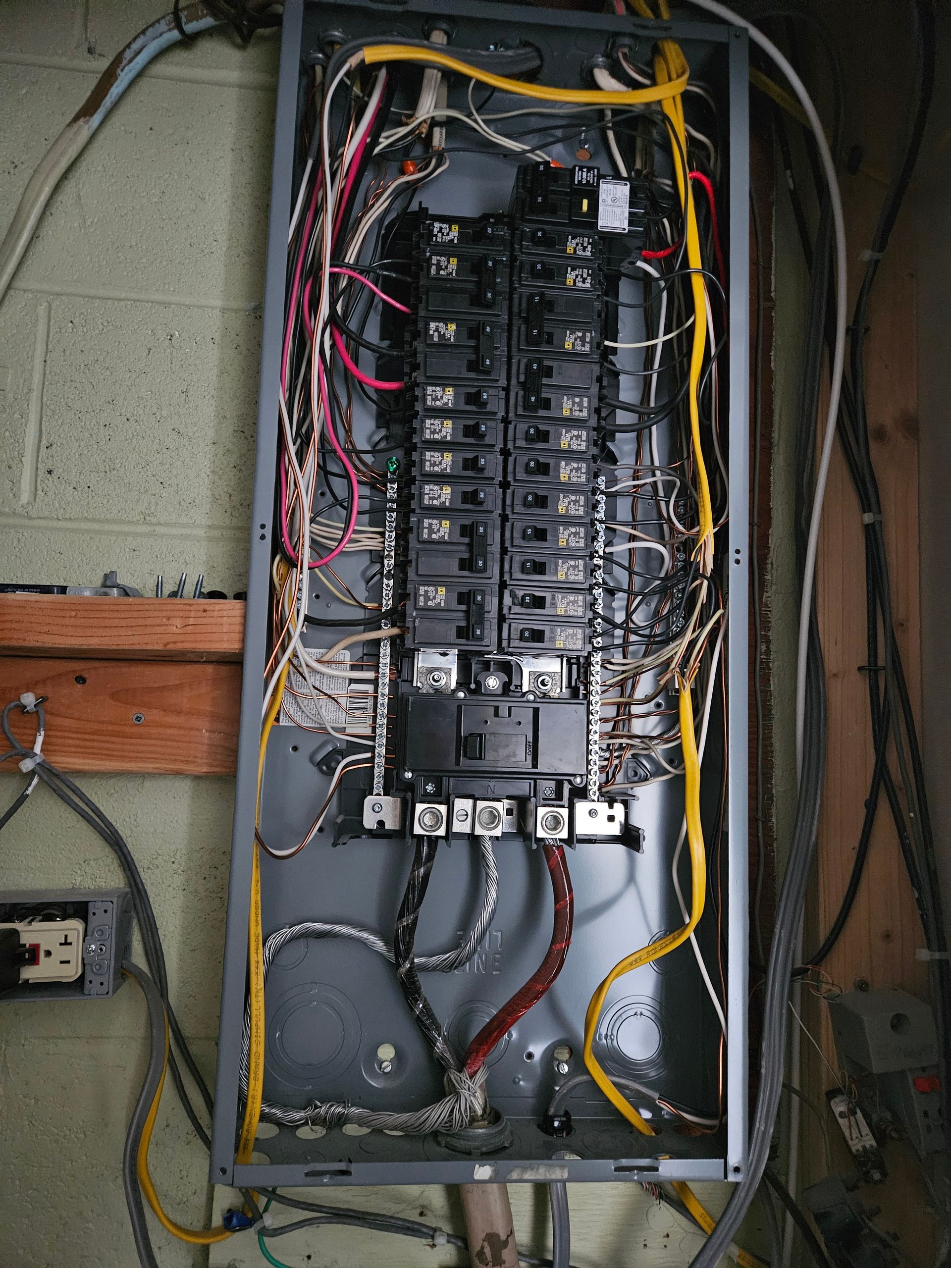 A very messy electrical box with a lot of wires coming out of it