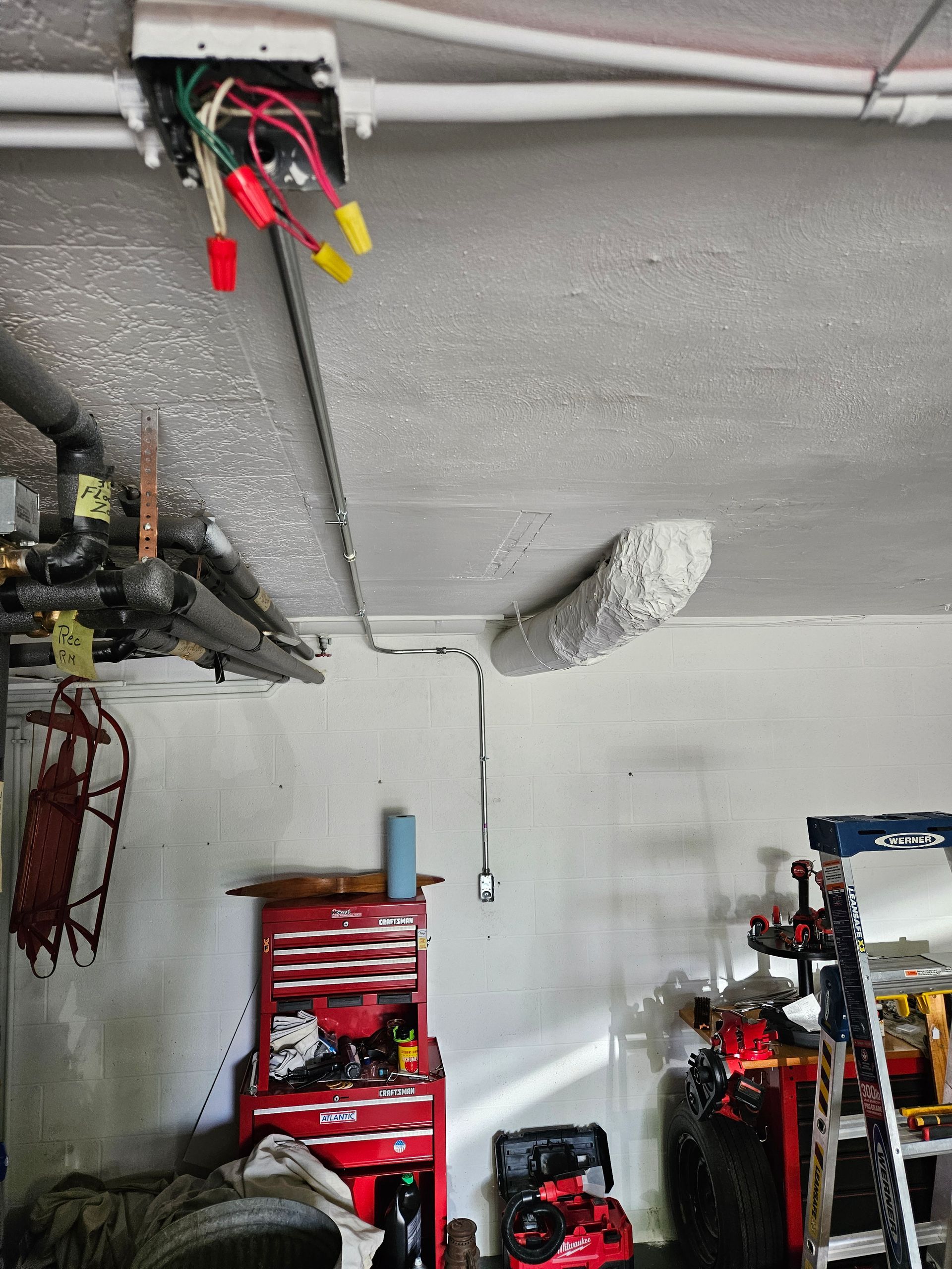 A garage with a lot of tools and a ladder