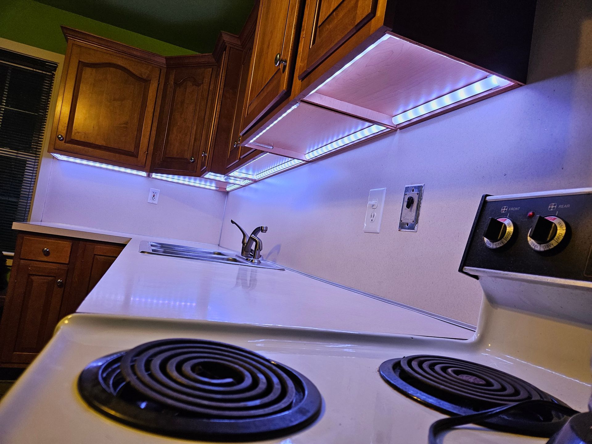 A kitchen with a stove top oven and a sink