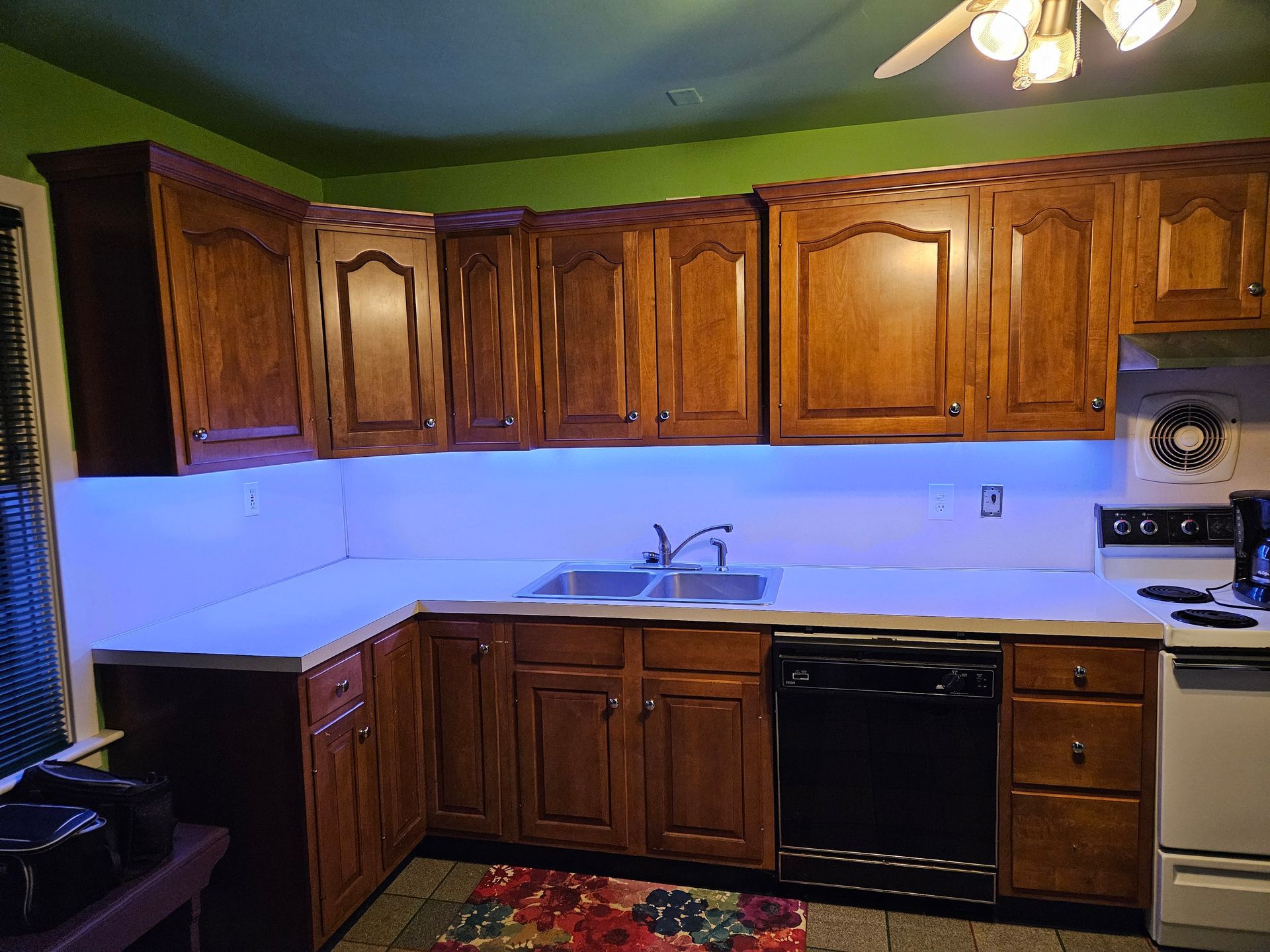 A kitchen with wooden cabinets and a stove and sink