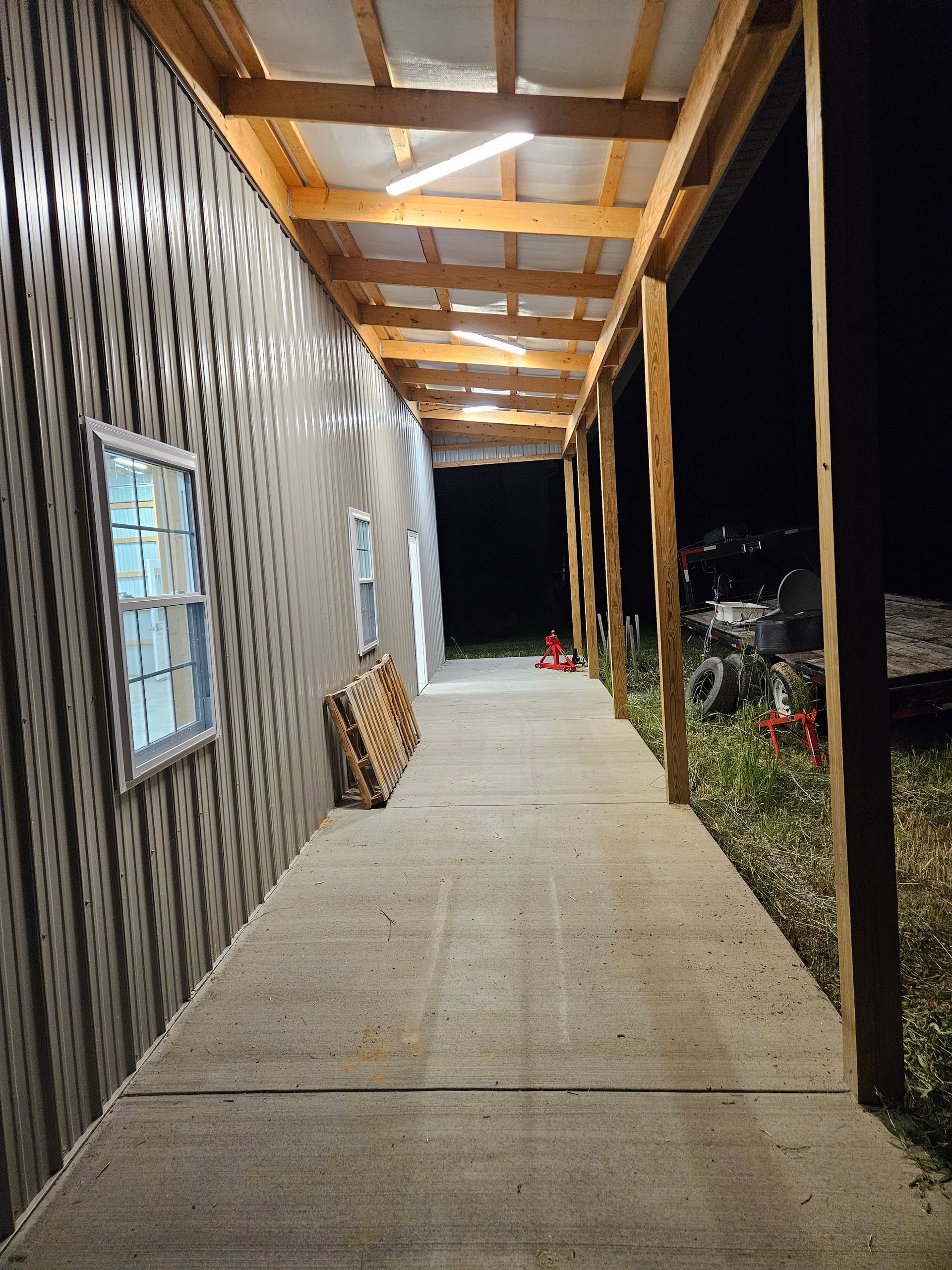 A long hallway leading to a building at night
